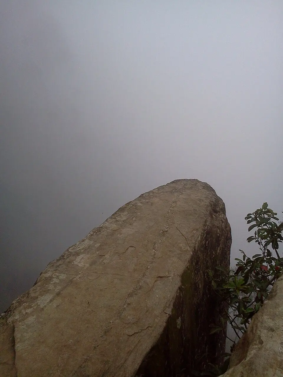 Trekkers on the Dolphin's Nose overhanging rock at sunset view, Vattakanal, Kodaikanal