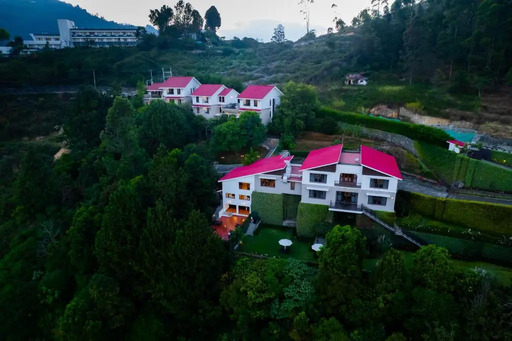 Colonial bungalow exterior of DVARA Kodaikanal boutique resort surrounded by pine trees, Vilpatti