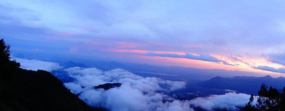 Sunrise over the 4,900-ft Green Valley View drop, Pillar Rocks Road, Kodaikanal