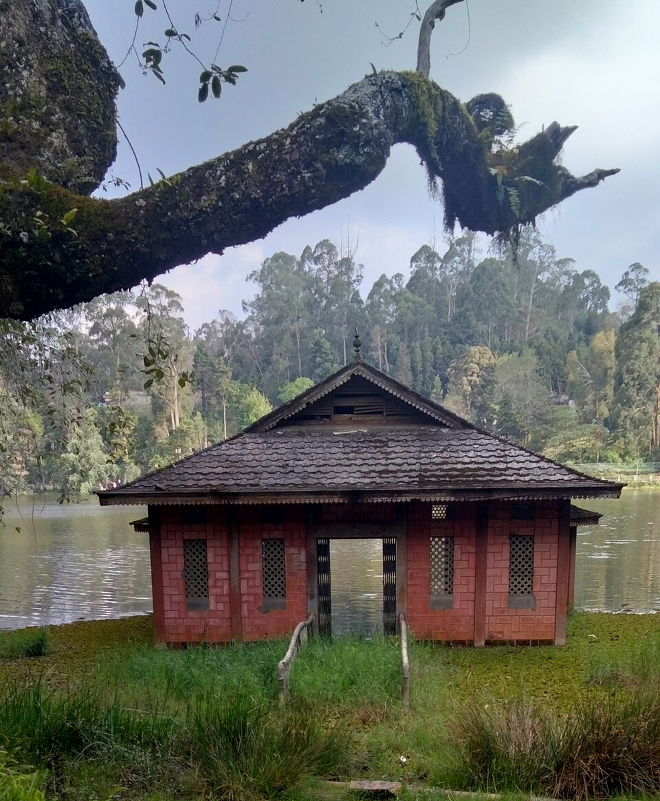 Berijam Lake boathouse surrounded by shola forest, Kodaikanal