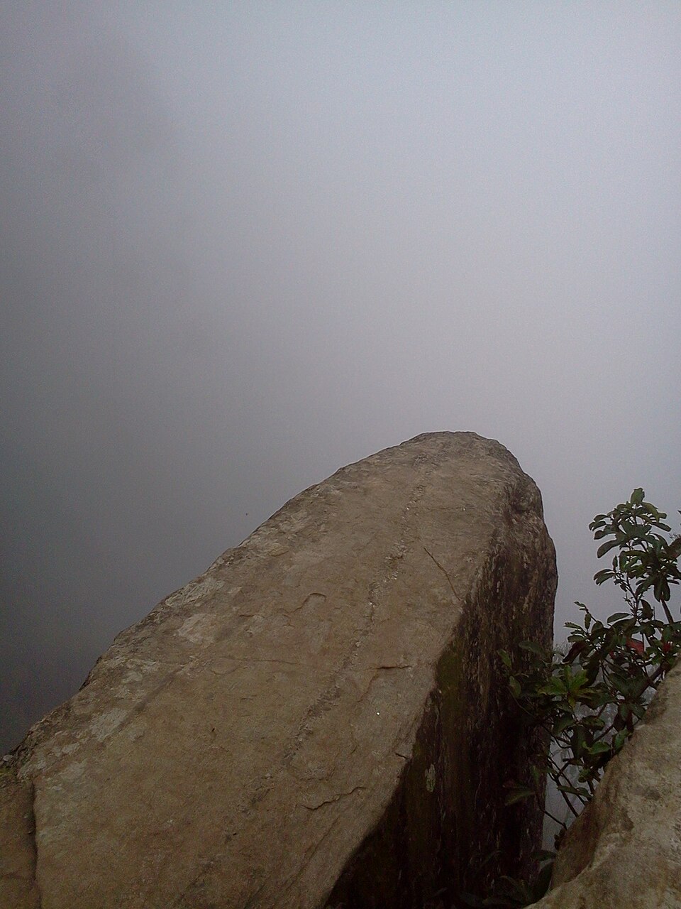 Trekkers on the Dolphin's Nose overhanging rock at dawn, Vattakanal, Kodaikanal
